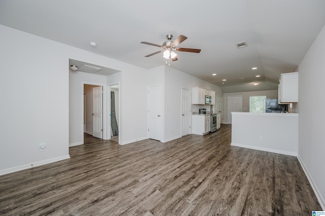 unfurnished living room with ceiling fan, vaulted ceiling, and dark hardwood / wood-style floors