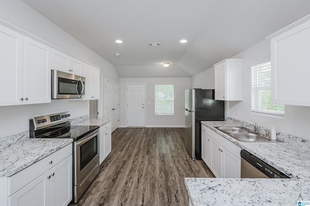 kitchen with stainless steel appliances, a wealth of natural light, and white cabinets