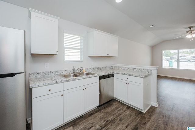 kitchen featuring lofted ceiling, dishwasher, fridge, kitchen peninsula, and sink