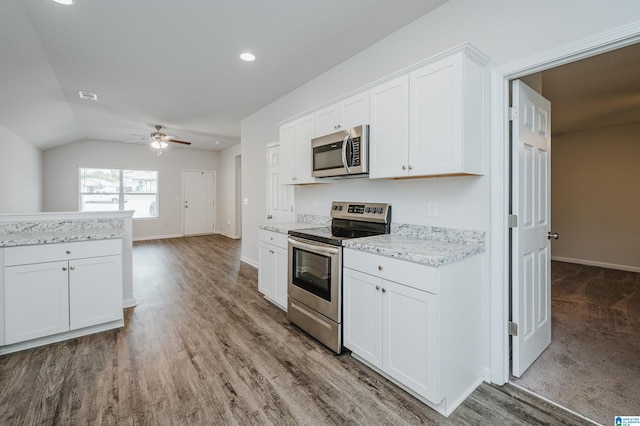 kitchen with white cabinetry, appliances with stainless steel finishes, lofted ceiling, and wood-type flooring