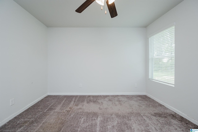 spare room featuring carpet floors and ceiling fan