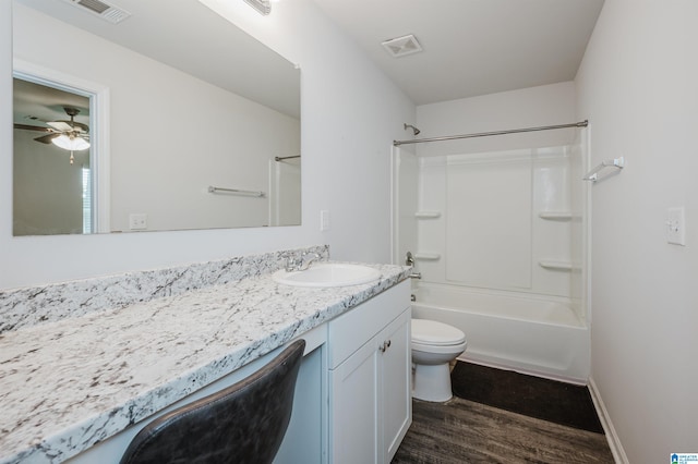 full bathroom featuring shower / washtub combination, hardwood / wood-style floors, ceiling fan, toilet, and vanity