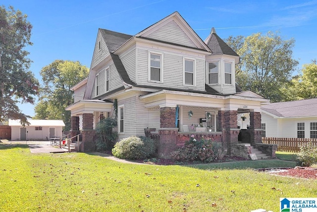 view of front of property with covered porch and a front yard