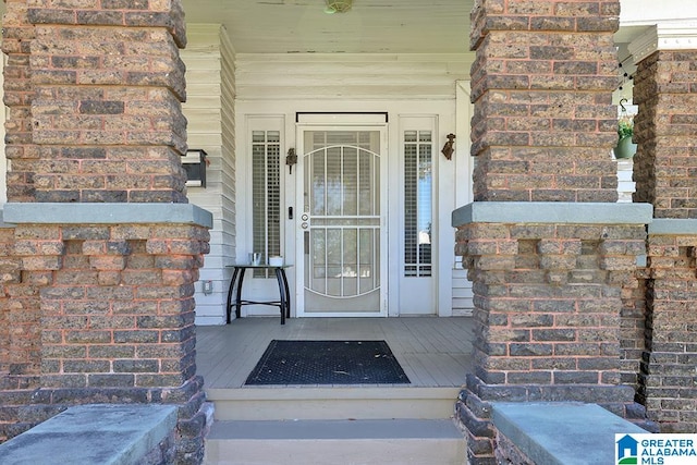 view of exterior entry with covered porch