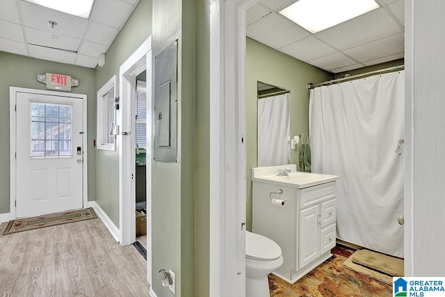 bathroom with vanity, toilet, a paneled ceiling, and hardwood / wood-style floors