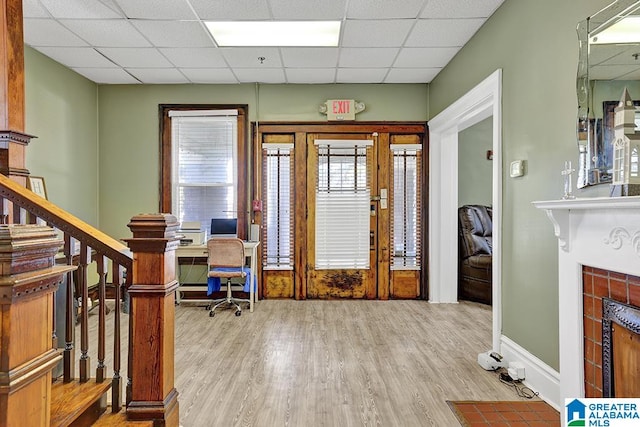 entrance foyer with a paneled ceiling and light wood-type flooring