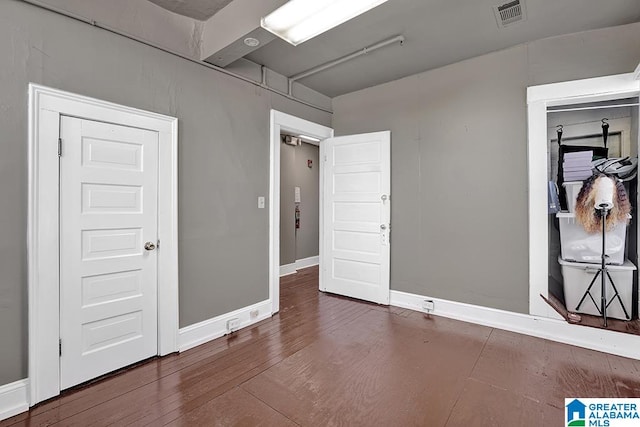 empty room featuring dark wood-type flooring