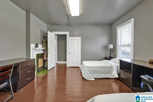 bedroom with dark wood-type flooring