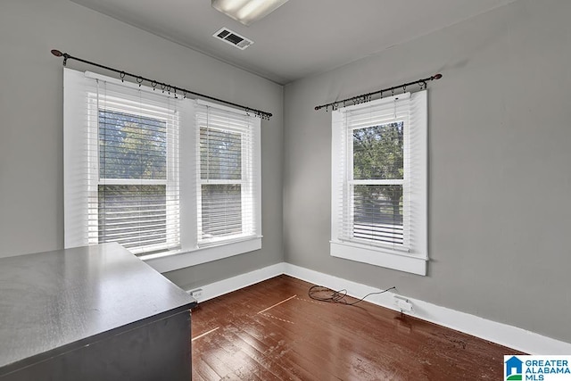 unfurnished dining area featuring dark hardwood / wood-style flooring