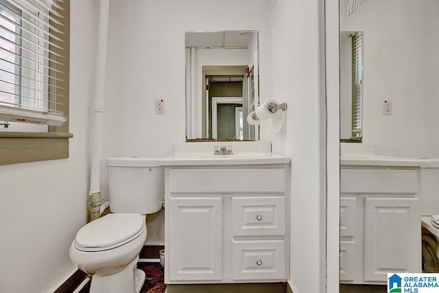 bathroom with toilet and vanity