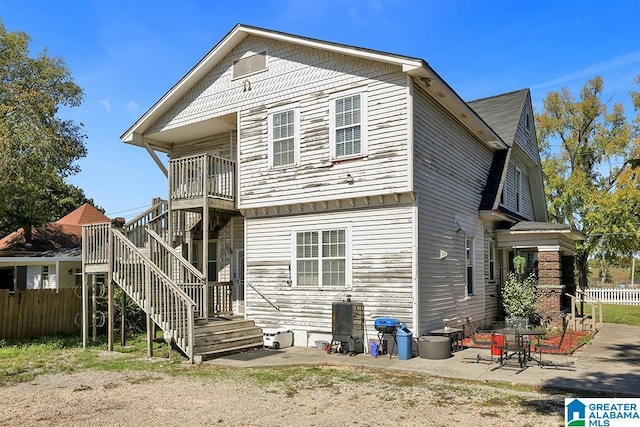 rear view of property featuring a patio