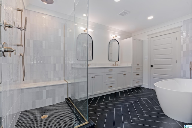 bathroom with tile patterned flooring, shower with separate bathtub, and vanity