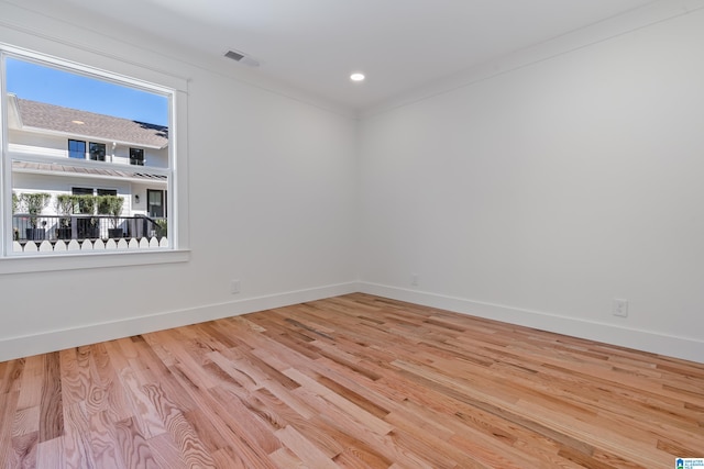 unfurnished room featuring light hardwood / wood-style floors and ornamental molding