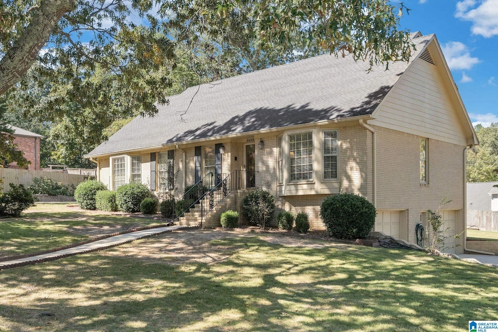 ranch-style house featuring a front lawn and a garage