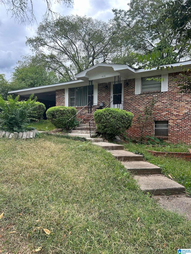 ranch-style home with a front yard and a carport