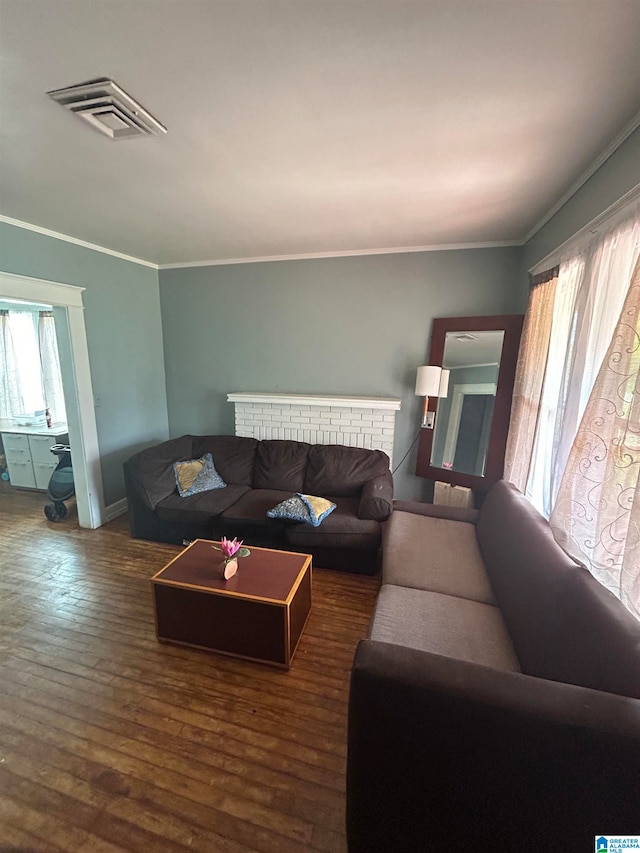 living room with ornamental molding and dark wood-type flooring