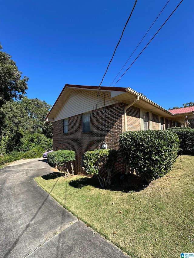 view of property exterior featuring a lawn