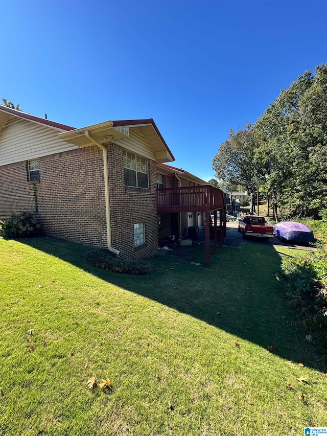 view of property exterior with a deck and a lawn