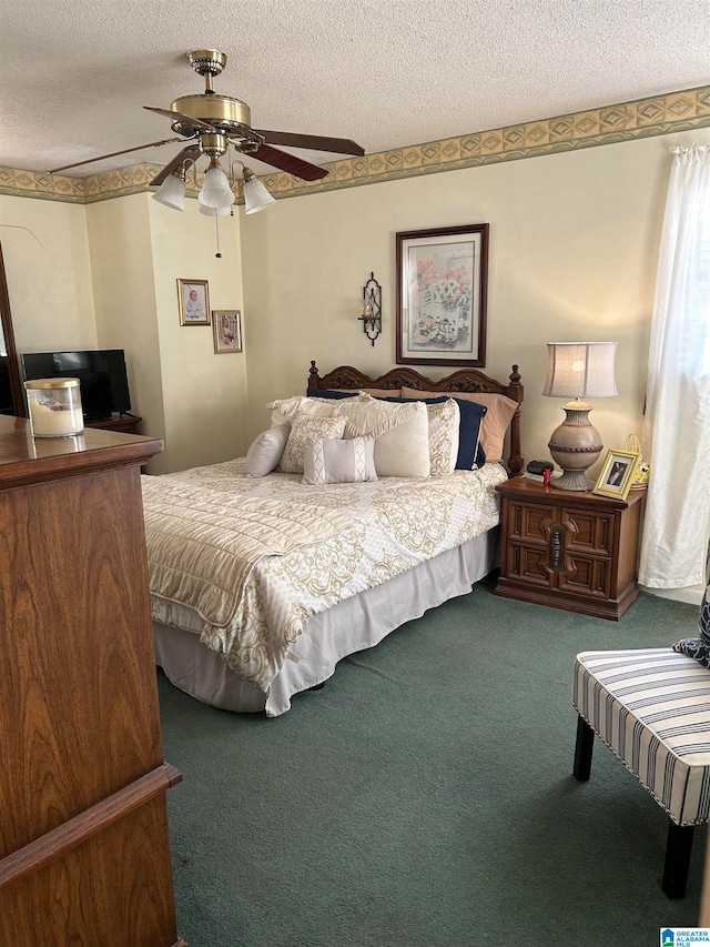 carpeted bedroom featuring ceiling fan and a textured ceiling