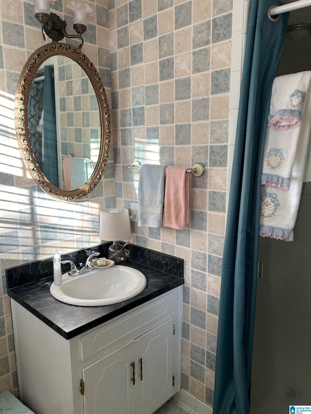 bathroom featuring tile walls, vanity, and decorative backsplash