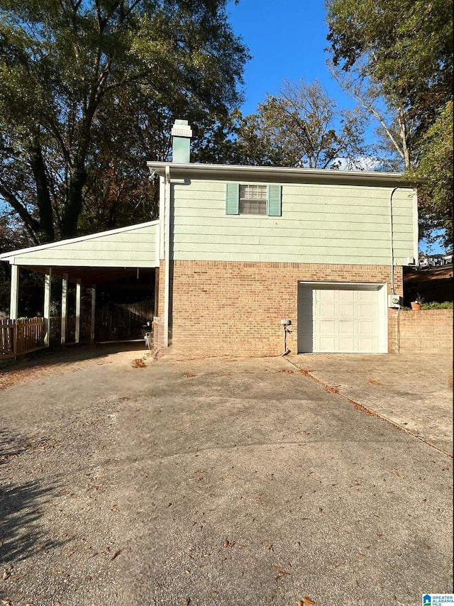 exterior space with a garage and a carport