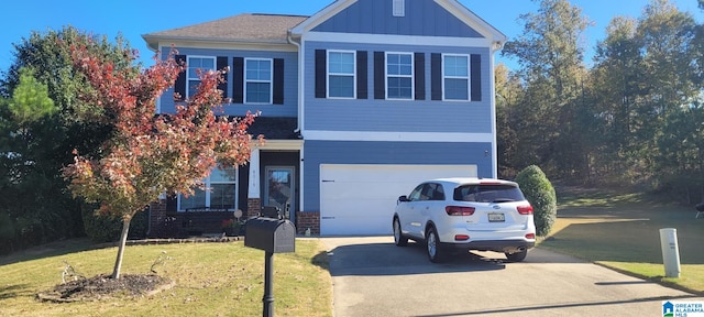 view of front of home with a front yard and a garage