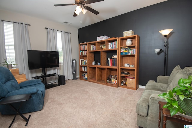 carpeted living room featuring ceiling fan