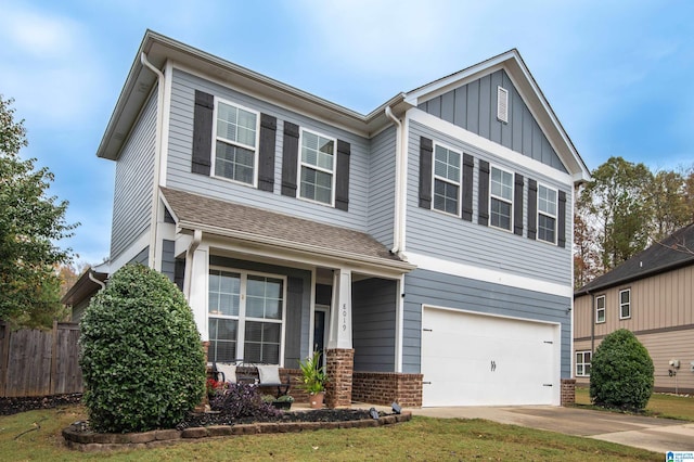 craftsman-style house with a front yard and a garage