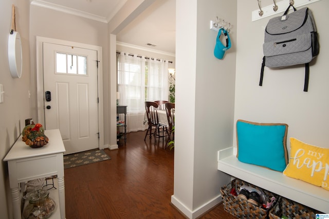 entryway with ornamental molding and dark hardwood / wood-style floors