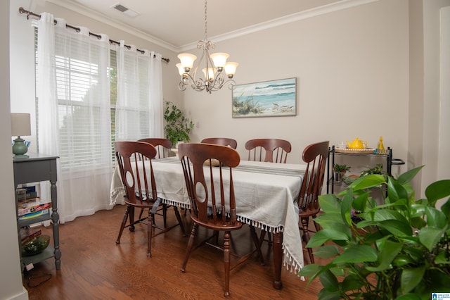 dining area with crown molding, an inviting chandelier, and dark hardwood / wood-style flooring