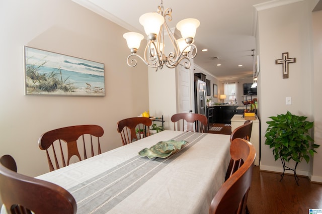 dining space featuring ornamental molding, dark hardwood / wood-style floors, and a chandelier