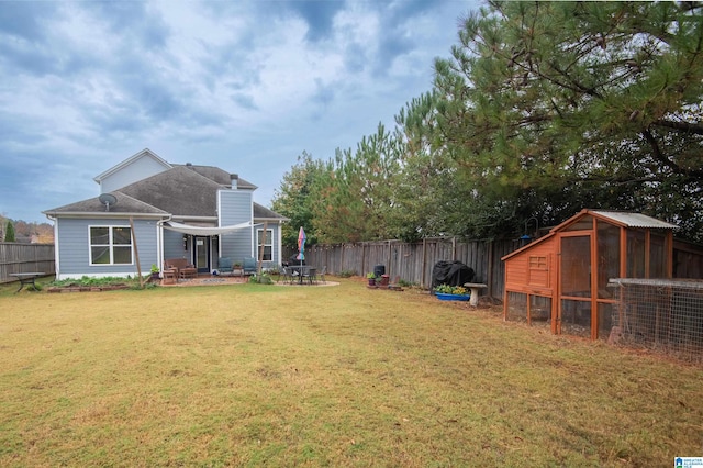 view of yard featuring a shed and a patio