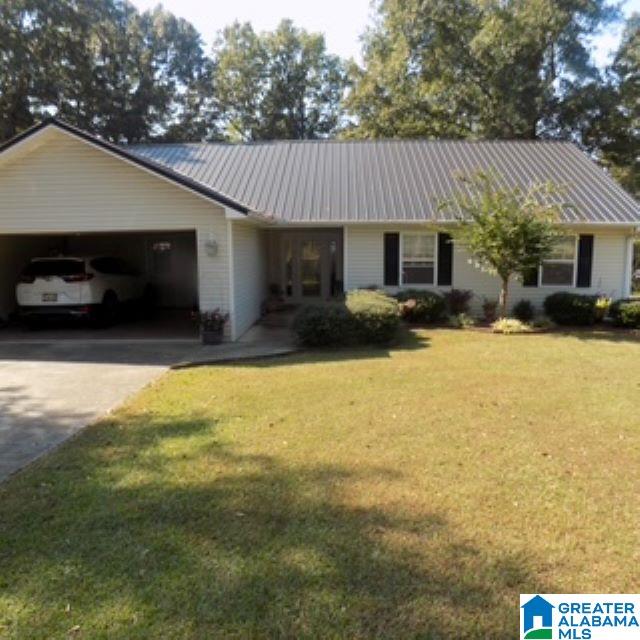 ranch-style home with a front yard and a garage