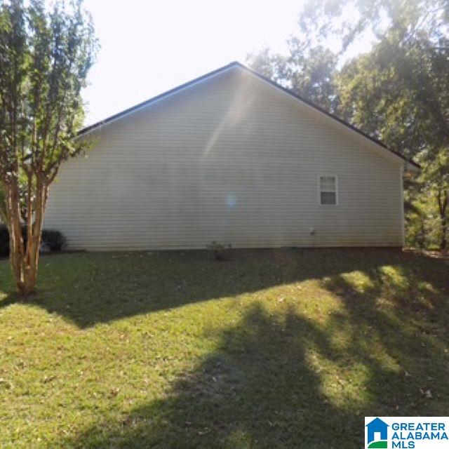 view of side of property featuring a yard