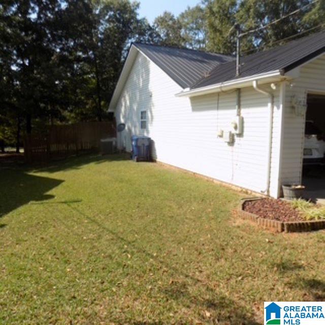 view of side of property with a yard