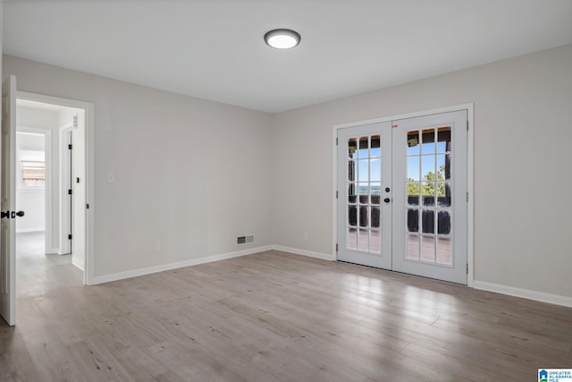 2720 20th Pl, Ensley, Birmingham, AL 35208 - empty room with french doors, wood finished floors, and baseboards