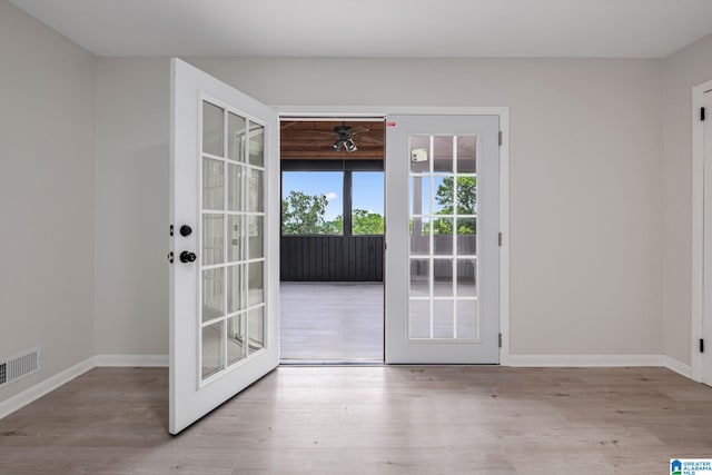 2720 20th Pl, Ensley, Birmingham, AL 35208 - doorway with french doors, wood finished floors, ceiling fan, and baseboards