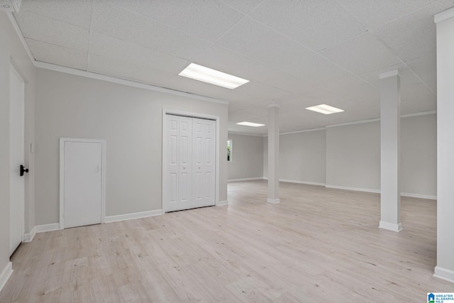 empty room with a paneled ceiling and light hardwood / wood-style flooring