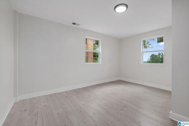 unfurnished room featuring light hardwood / wood-style floors and plenty of natural light