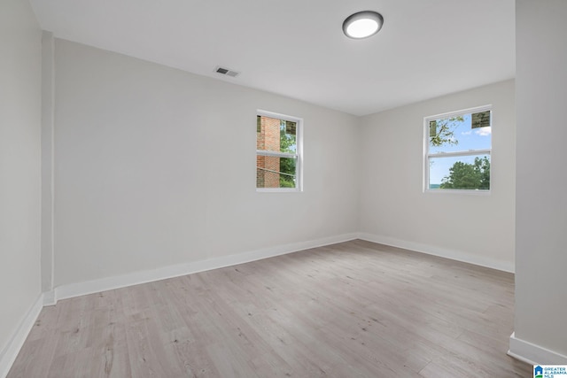 2720 20th Pl, Ensley, Birmingham, AL 35208 - empty room featuring plenty of natural light, light wood-style flooring, and baseboards