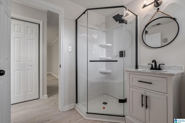 bathroom featuring vanity, hardwood / wood-style floors, and walk in shower