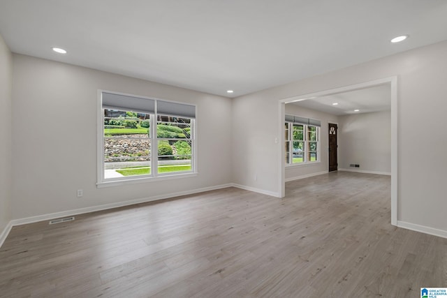 unfurnished room featuring light hardwood / wood-style floors and plenty of natural light