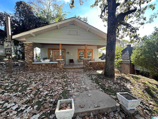 back of house featuring covered porch