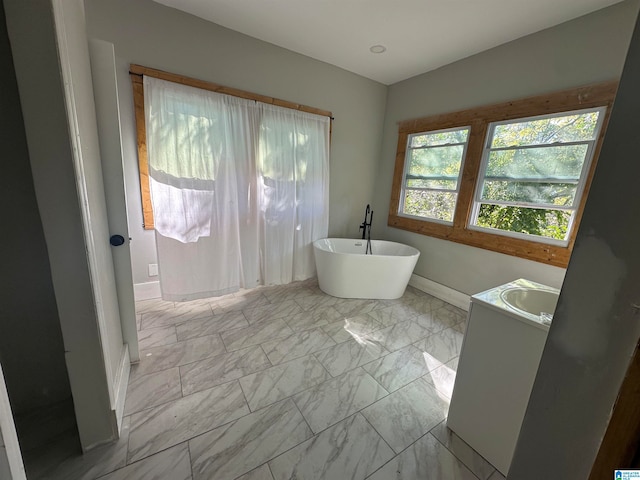 bathroom featuring sink and a bath