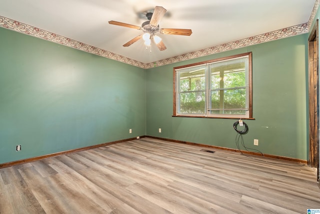 spare room with light hardwood / wood-style floors and ceiling fan