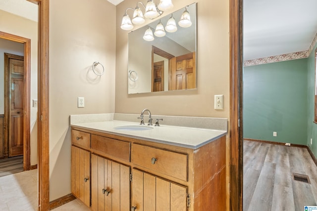 bathroom with vanity and hardwood / wood-style floors