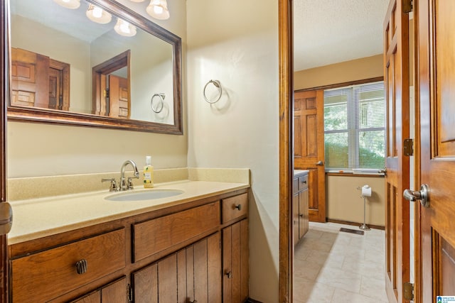 bathroom featuring vanity and a textured ceiling