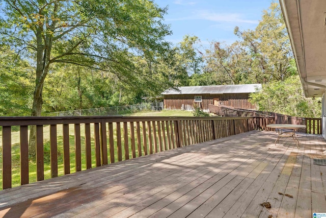 wooden terrace featuring a lawn