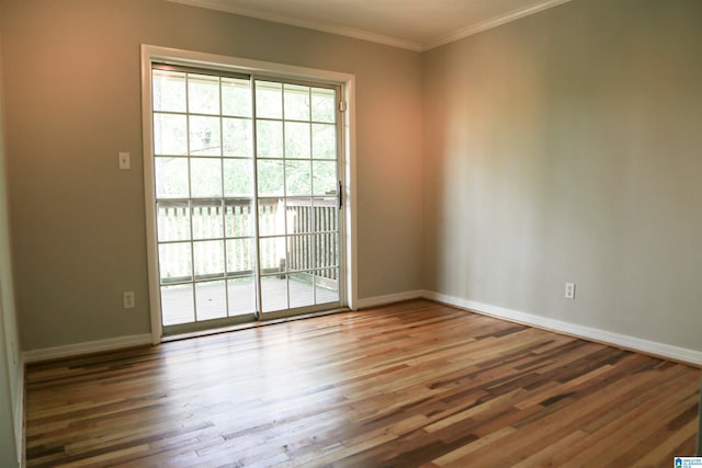 unfurnished room featuring ornamental molding and wood-type flooring