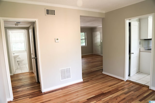 hallway featuring crown molding, wood-type flooring, and a textured ceiling